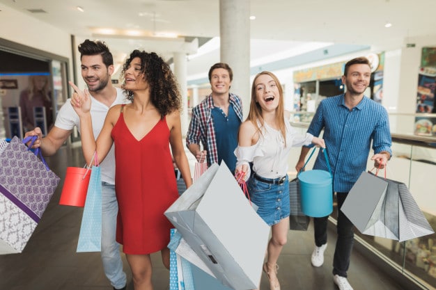 group of friends with bags at a shopping mall