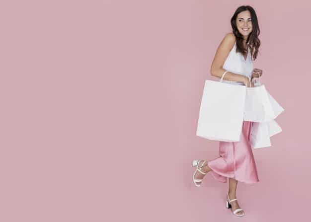 woman holding white shopping bags